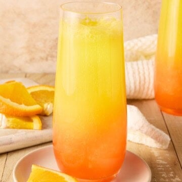 single tequila sunrise mimosa with orange slices.