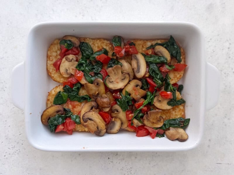 hash browns with vegetables on top;