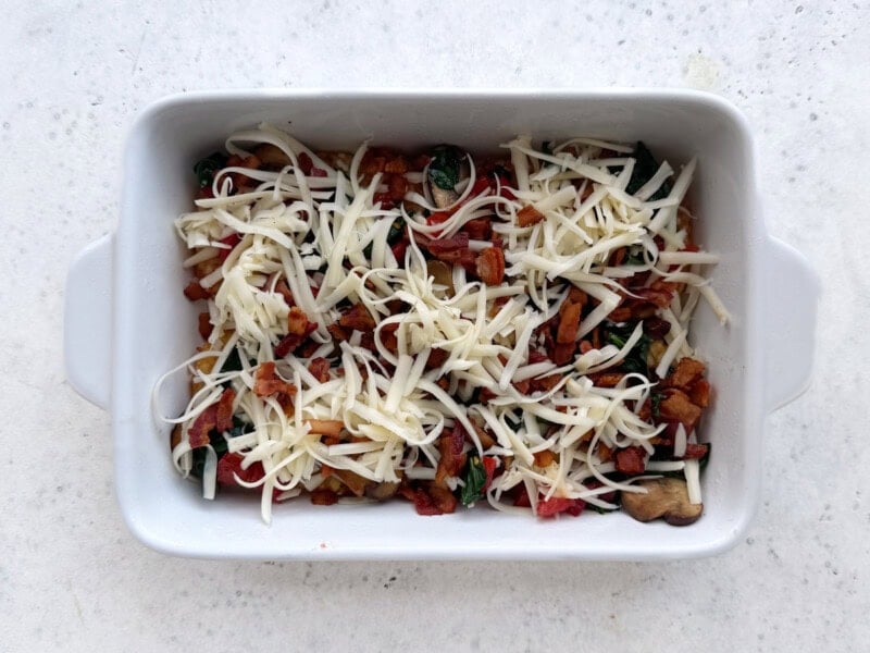 shredded cheese on top of hash browns and veggies.