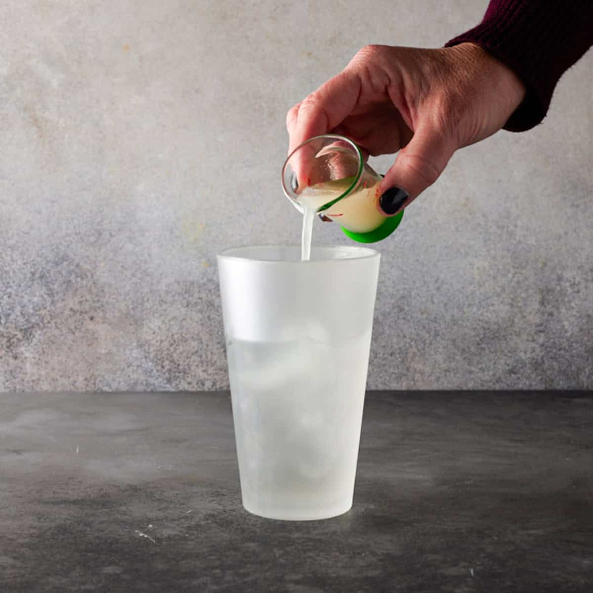 Lemon Juice being poured in a shaker.