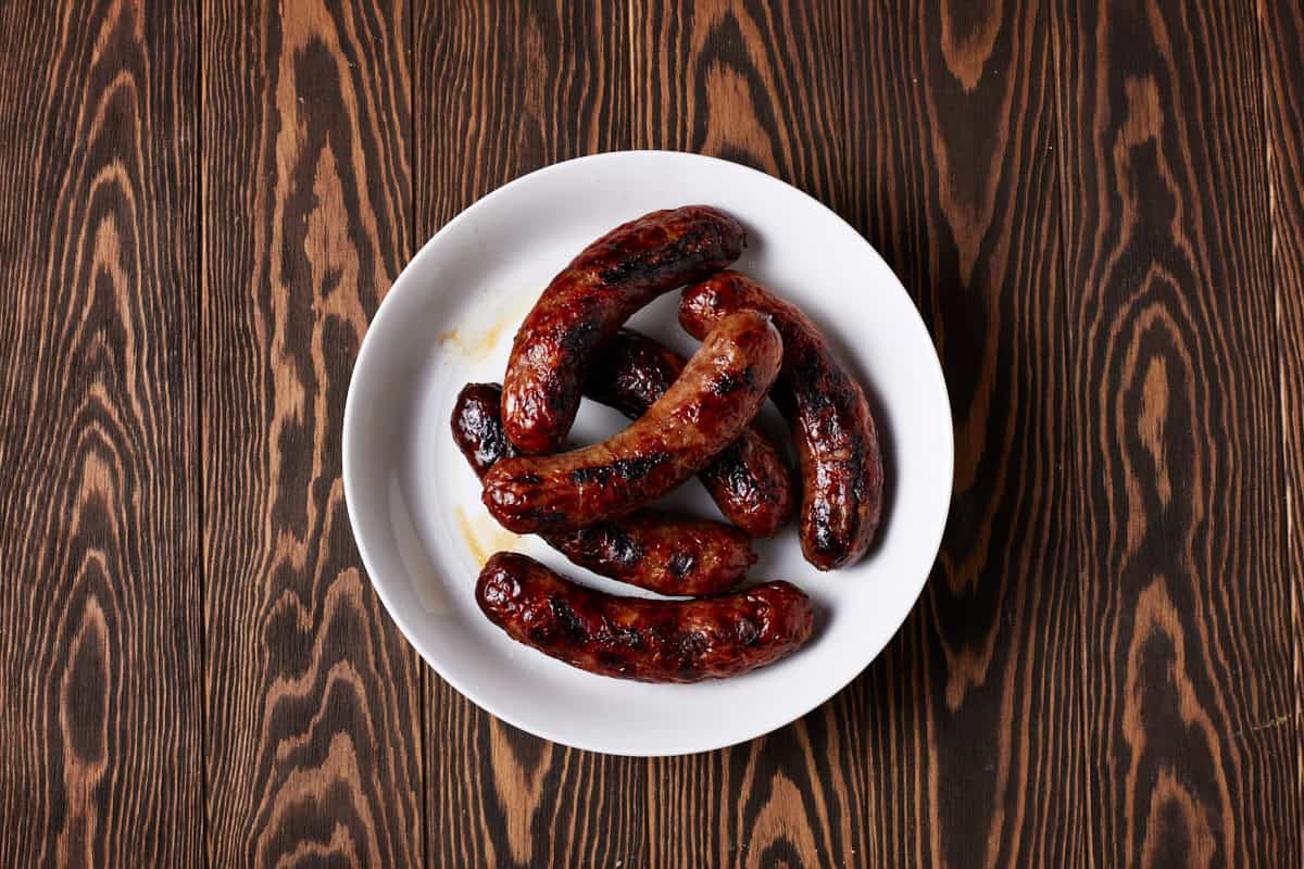 Grilled brats in bowl.