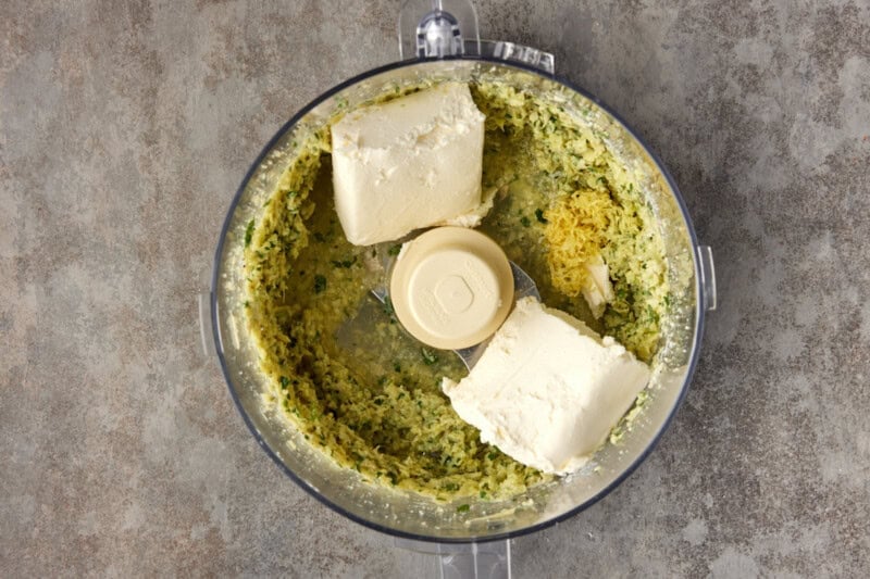 Cream cheese, lemon rind and cheese with chopped up artichoke in a food processor.