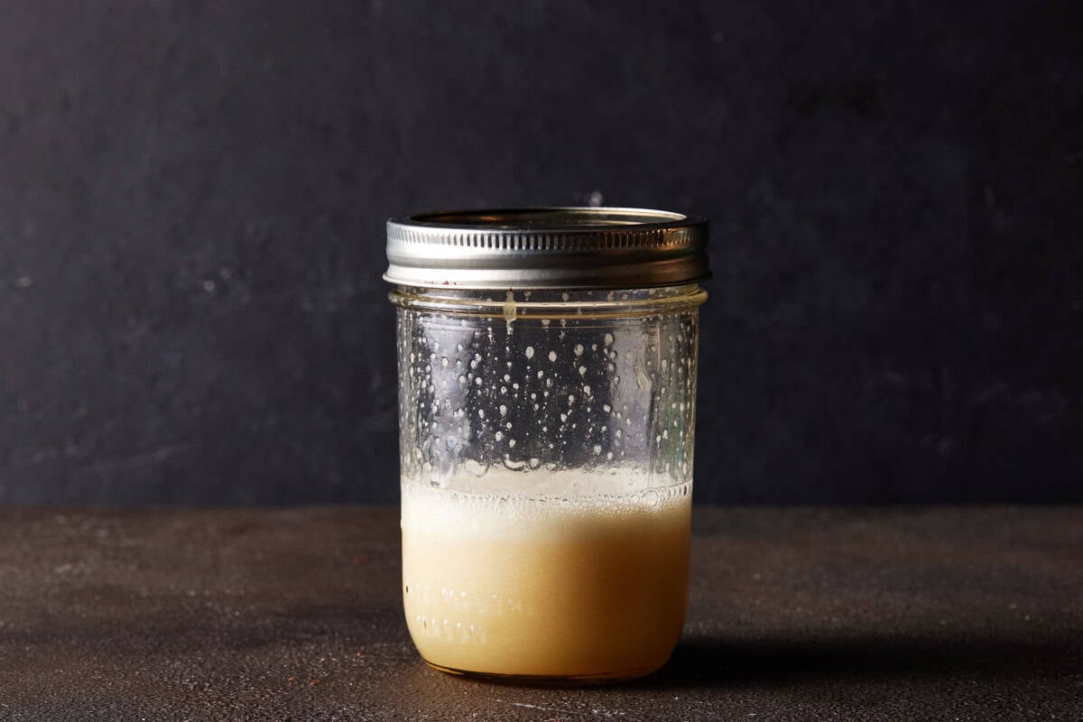 Shaker without ice and filled with foamy rum sour.