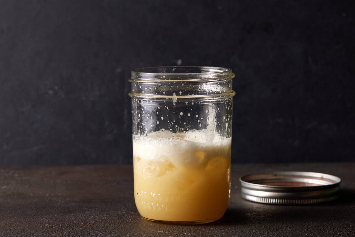 Rum sour in shaker with ice.
