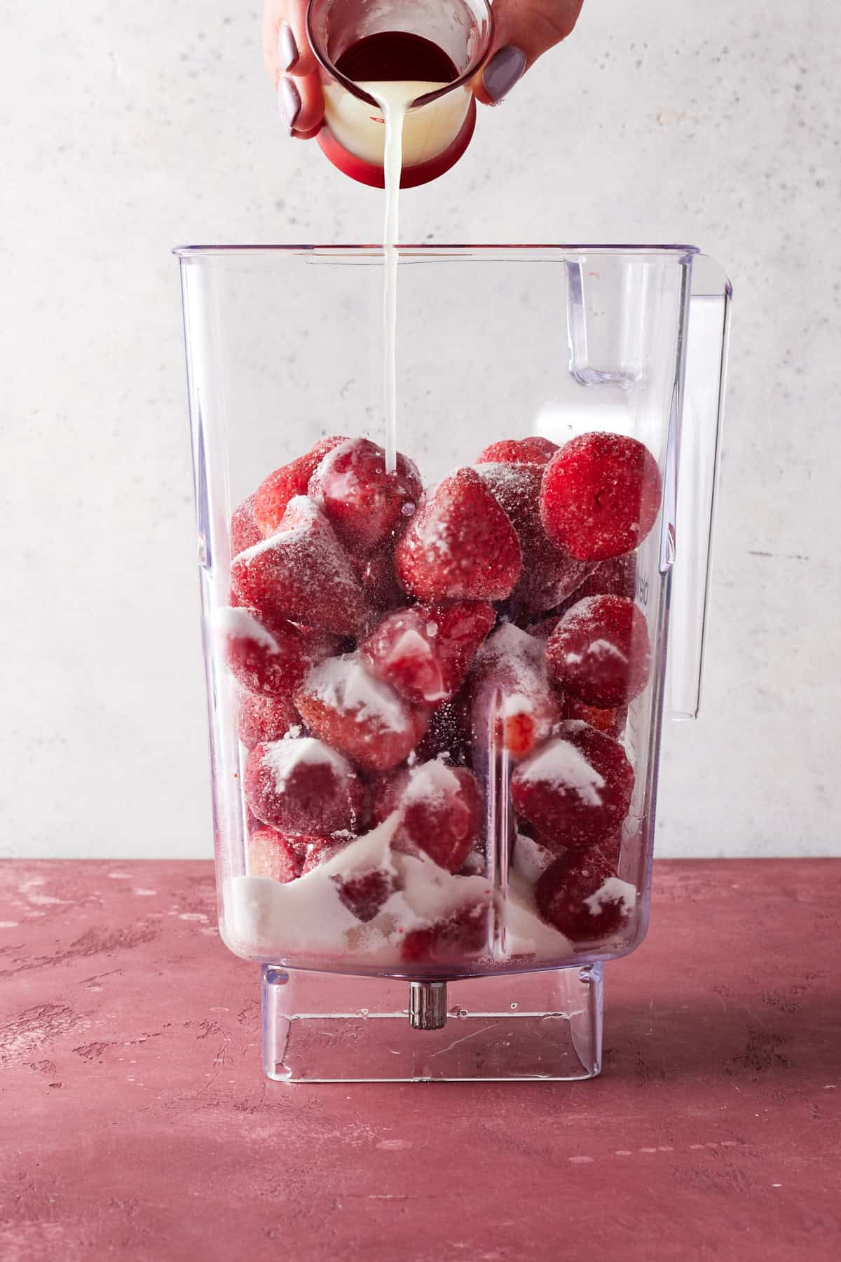 Lime juice being poured into blender.