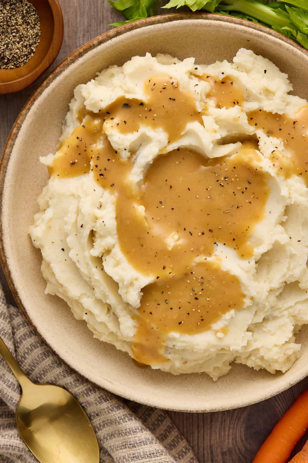 Mashed potatoes topped with make ahead gravy and sprinkled with pepper.