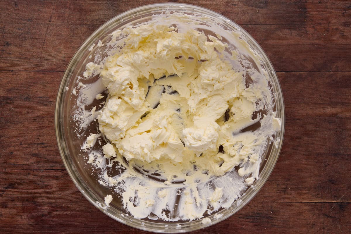 cream cheese and butter mixed smooth in glass bowl.
