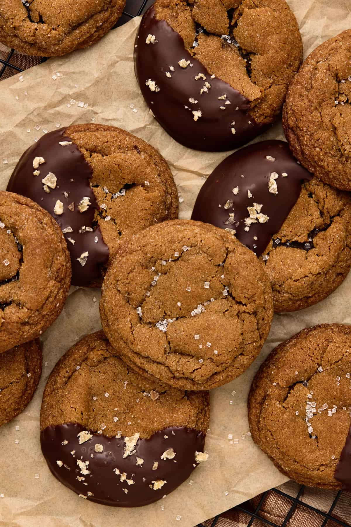 Close up of Chocolate Dipped Chewy Ginger Molasses Cookies on parchment paper.