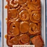 12 gooey caramel rolls on a sheet pan.