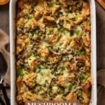 Mushroom and leek bread pudding in a white casserole dish.
