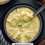 Broccoli Cheddar soup in tow bowls with a bowl of croutons.