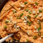 Close up of buffalo chicken dip in a cast iron pan.