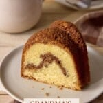 Sliced cinnamon swirl sour cream coffee cake on an ivory plate.