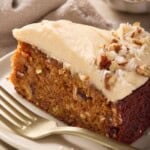 Close up image of a slice of single layer carrot cake on a cream plate.