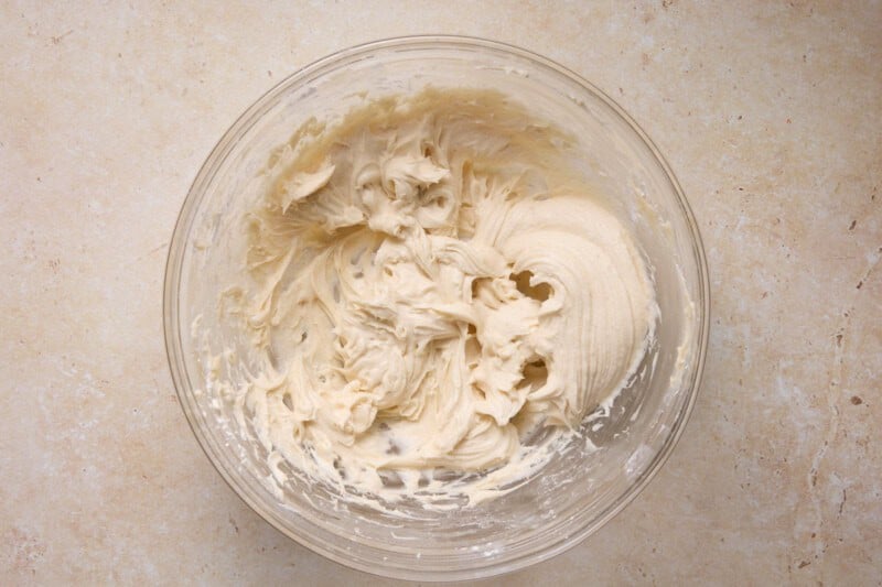 Brown butter cream cheese frosting in a glass bowl.