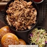 Pulled pork in bowl with buns and slaw on side.