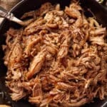 Pulled pork in a bowl with bbq sauce.