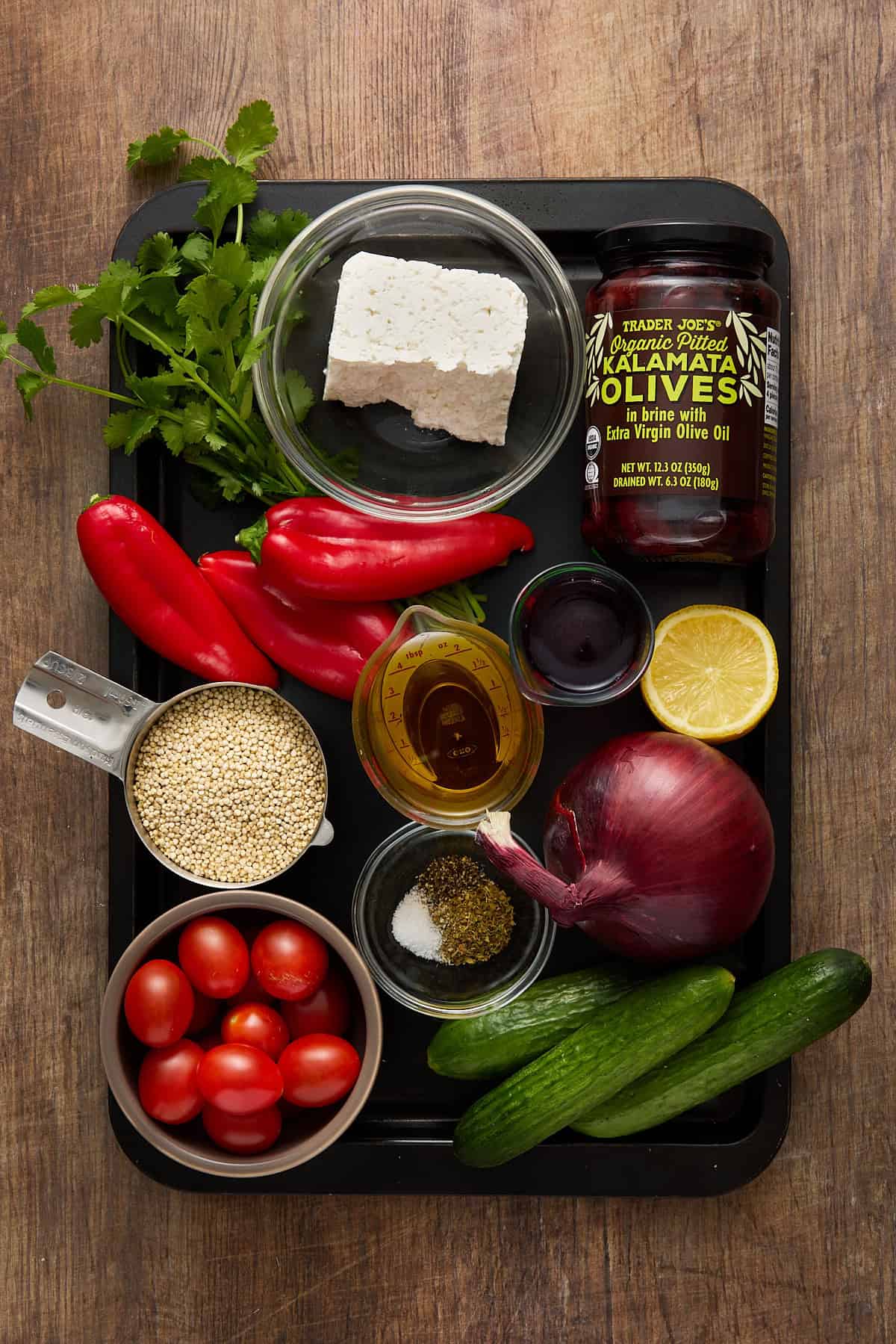 All of the fresh ingredients needed to make greek quinoa salad.