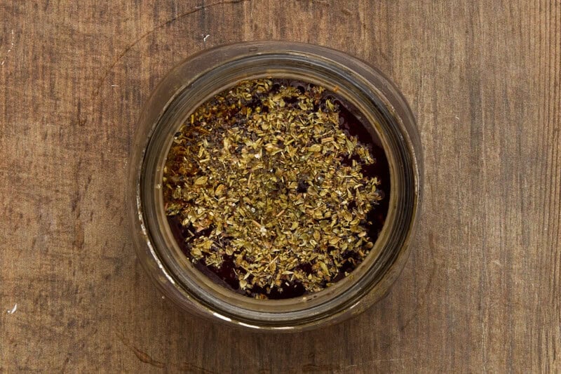 Red wine vinaigrette ingredients in jar.