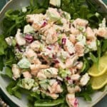 Shrimp Salad and arugula with avocado on a plate.