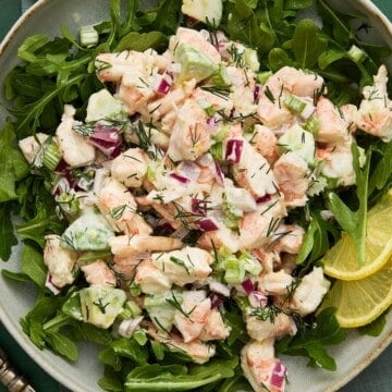 Shrimp Salad and arugula with avocado on a plate.