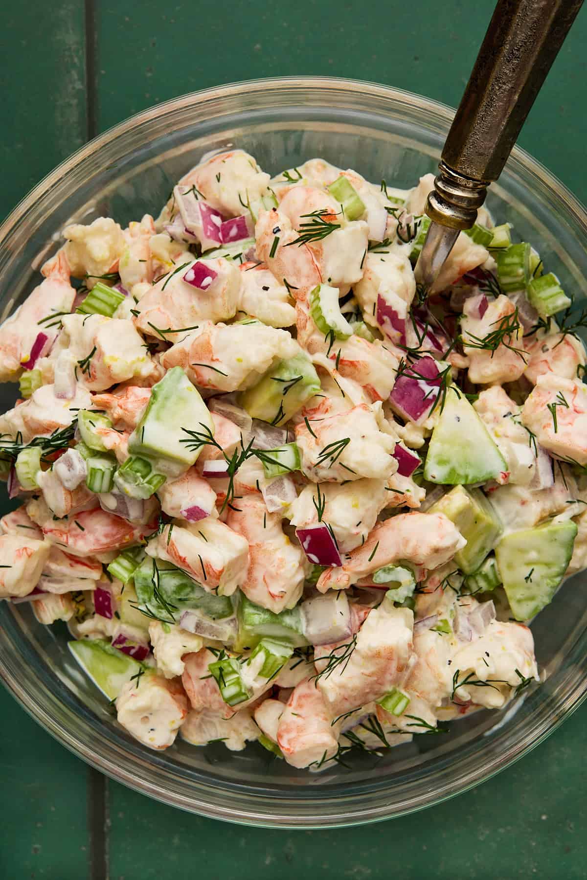 Shrimp Salad in a bowl with avocado and a spoon.