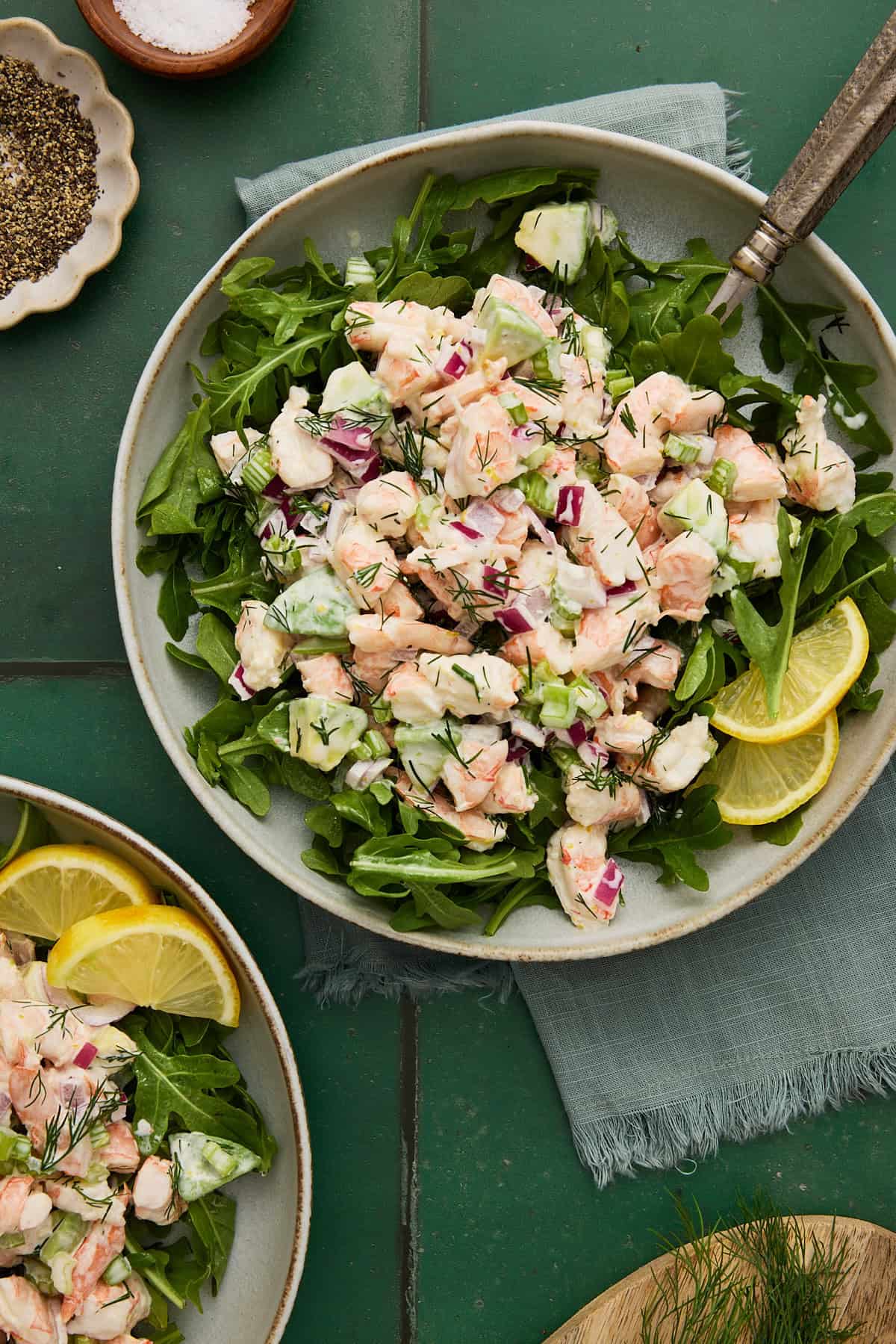 Shrimp Salad piled on arugula with avocado and lemon slices.