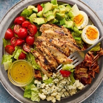 Honey Mustard Chicken sliced and placed on top of a cobb salad.