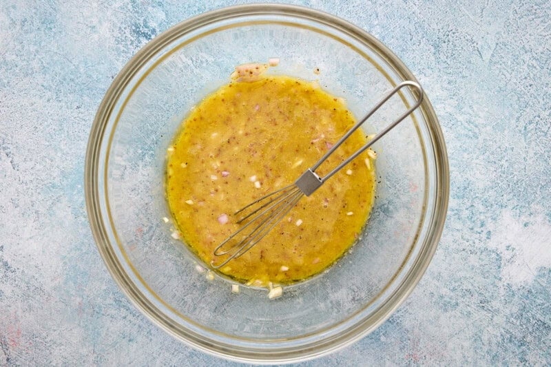 Honey mustard marinade whisked together in a glass bowl.