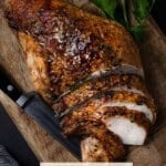 Sliced Herb Roasted Bone-In Turkey Breast on cutting board.