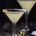 Two lemon drop martinis with lemon twists.