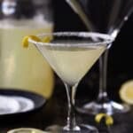 Lemon Drop martini in a sugar rimmed glass with shaker in back.