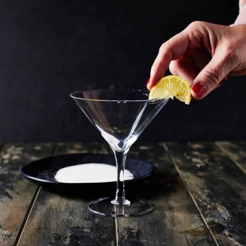 Lemon wedge around martini glass.