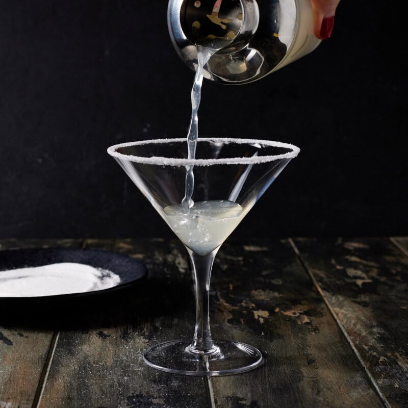 Straining into martini glass rimmed with sugar.