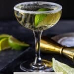 single coupe glass filled with elderflower gin cocktail.