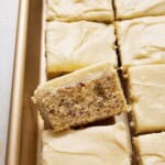Sliced banana bars in gold sheet pan.
