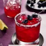Blueberry Margarita in a low ball glass with a half filled shaker behind.