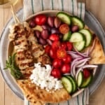 Chicken Souvlaki Pita Bowls with fresh veggies and feta cheese with extra pita on the side.