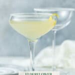 Elderflower Lemon Drop Martini on a white background with lemon wedges and twist.