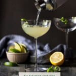 shaker pouring Elderflower Martini into tall coupe glass.
