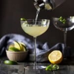 Elderflower Martini being poured out of shaker into coupe glass.