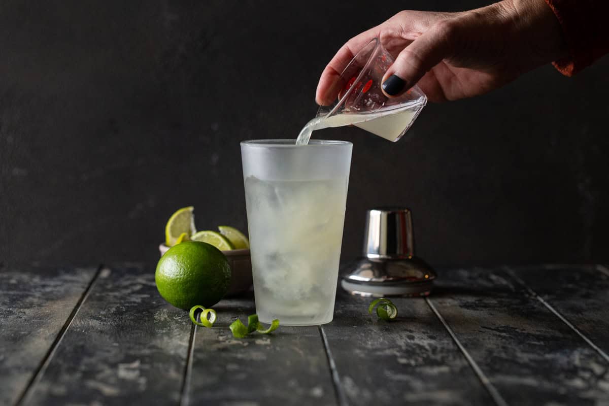Sweet and sour being poured into shaker.