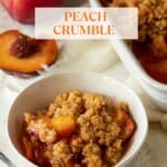 a bowl full of peach crumble with the pan in the background.
