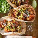 Shrimp Tacos with corn, lime wedges and chipotle cream.