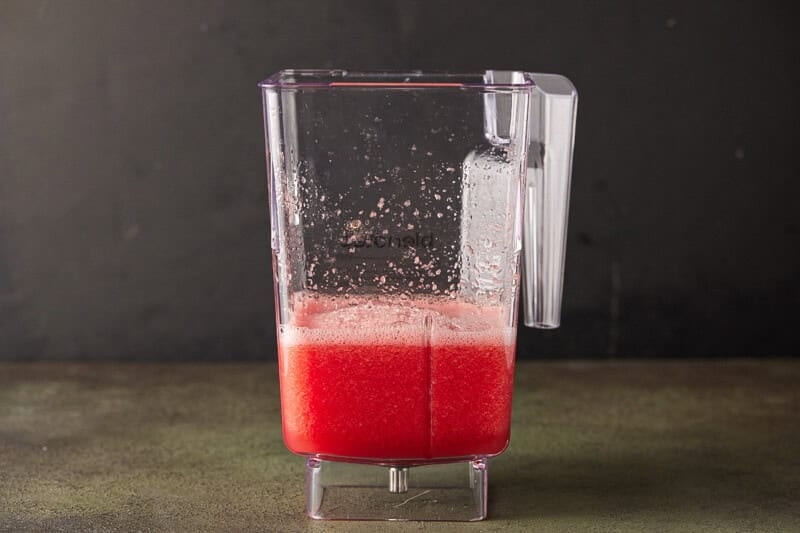 Watermelon juice pureed smooth in a blender jar.