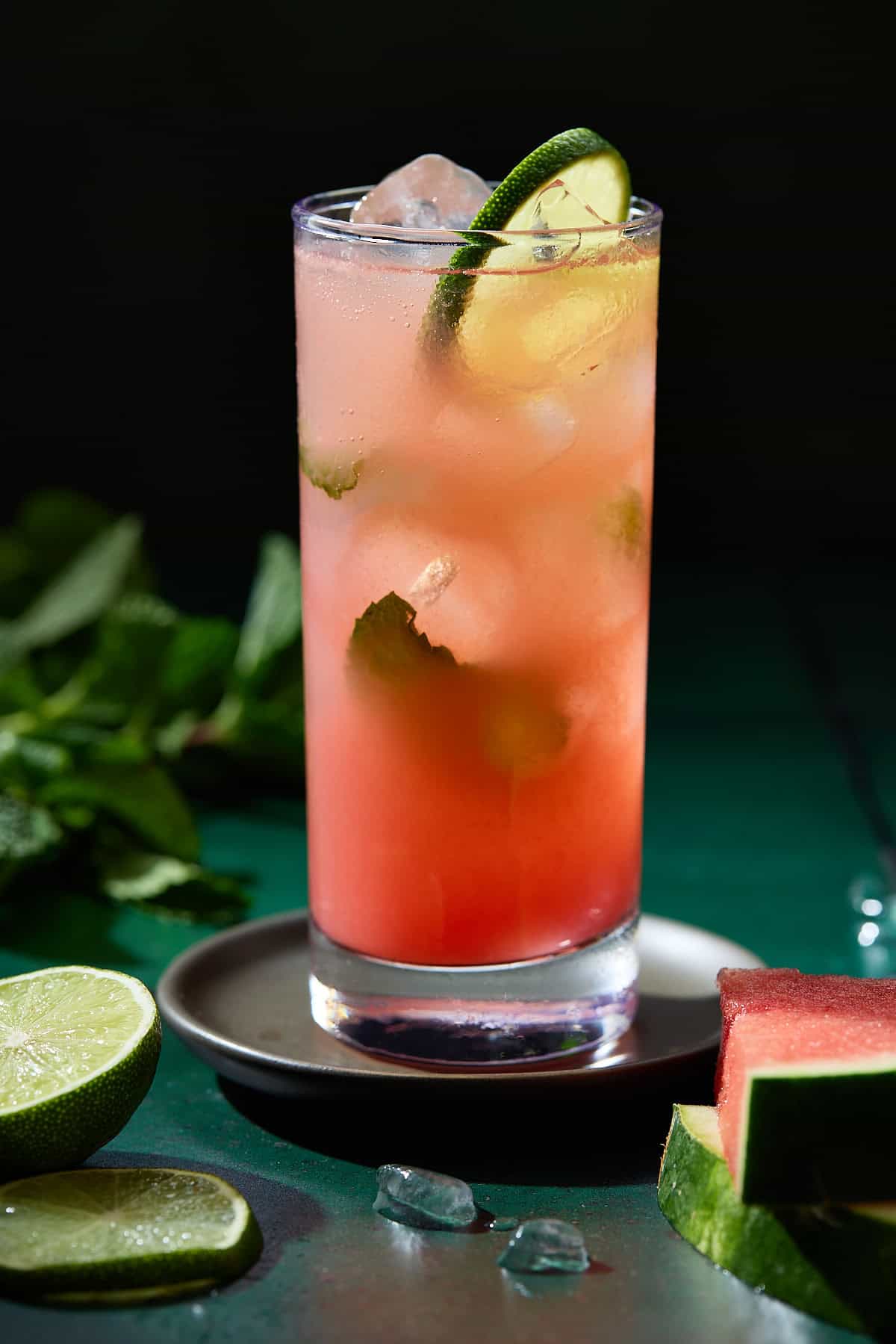A single highball glass of watermelon mojito cocktail.