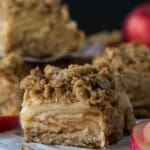 Slices of Apple Crisp Bars on parchment paper.