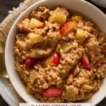 Baked steel cut oatmeal with apples and cinnamon in a bowl with syrup.
