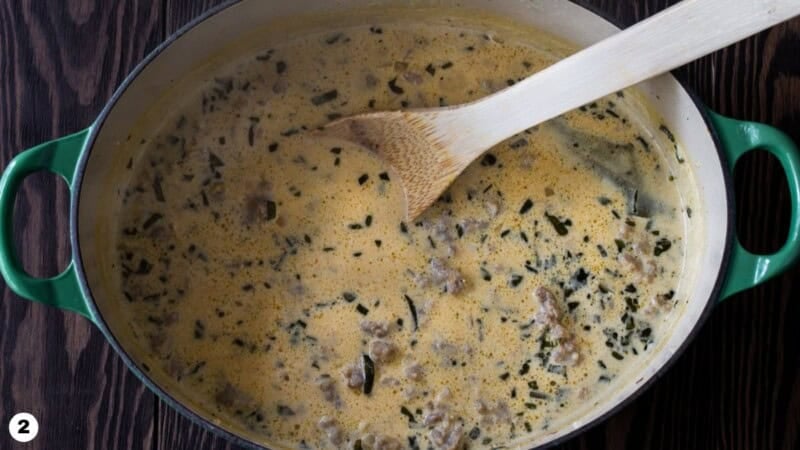 Pumpkin pasta sauce with sausage and sage in a dutch oven.